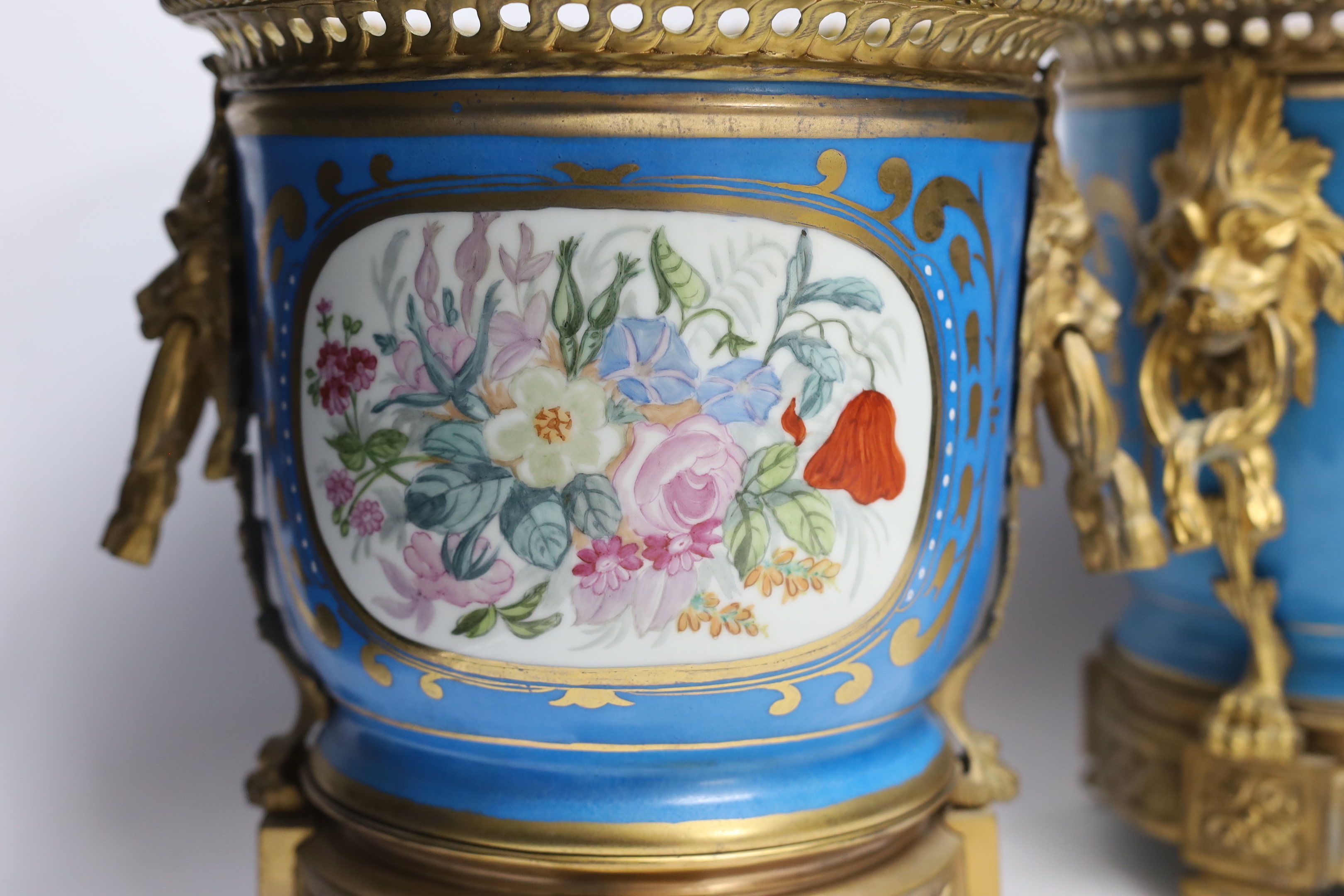 A pair of ormolu mounted Sevres style cache pots, 29cm high